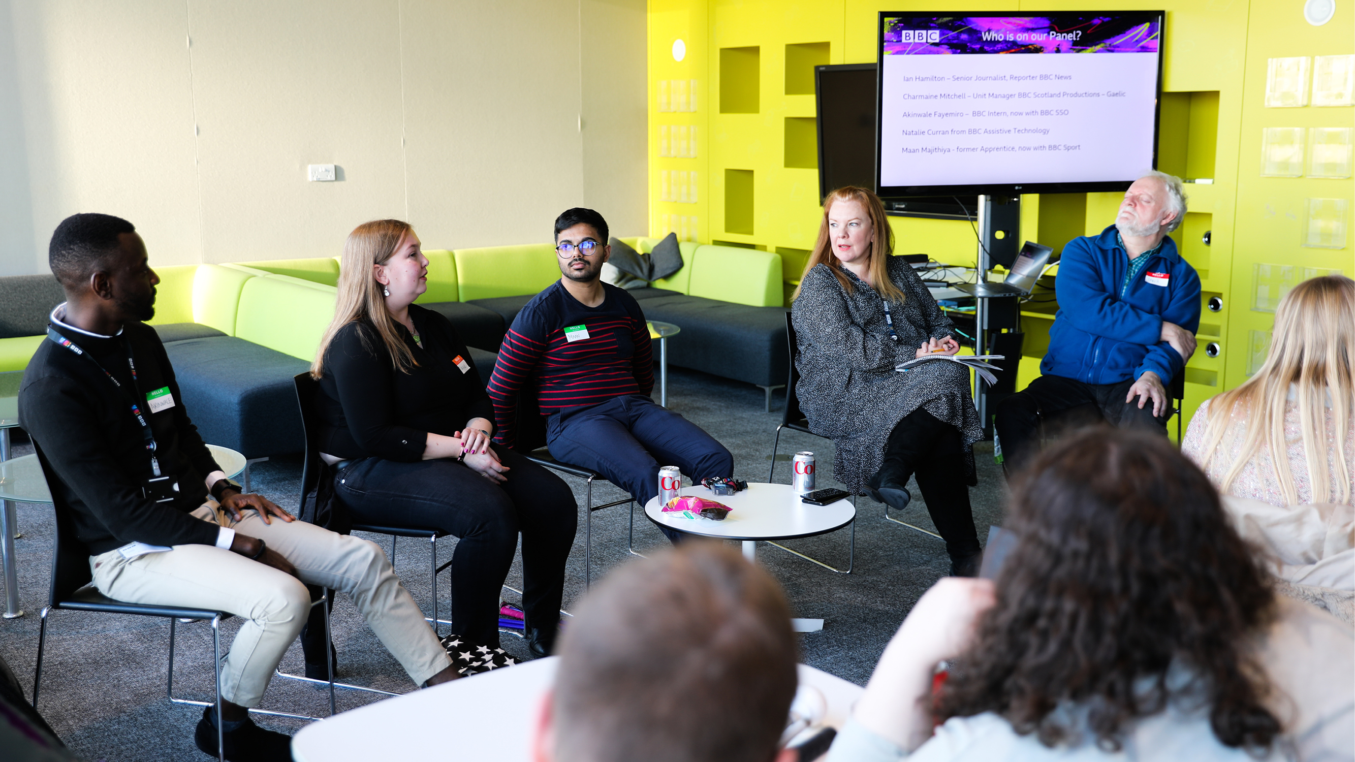Akinwale speaking on stage at a live event